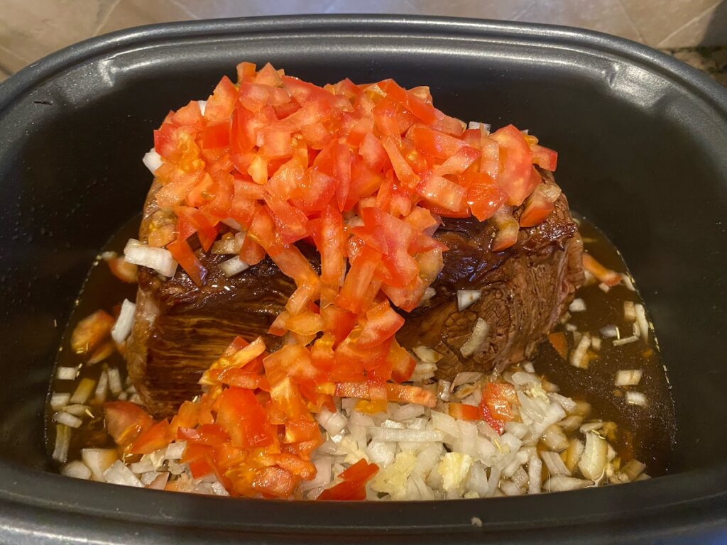 pot roast in slow cooker with tomatoes and liquid ingredients