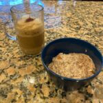 hot cereal recipe in bowl on kitchen island next to cup of coffee