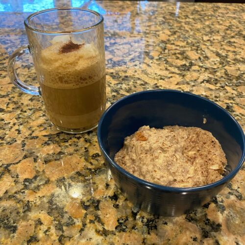 hot cereal recipe in bowl on kitchen island next to cup of coffee