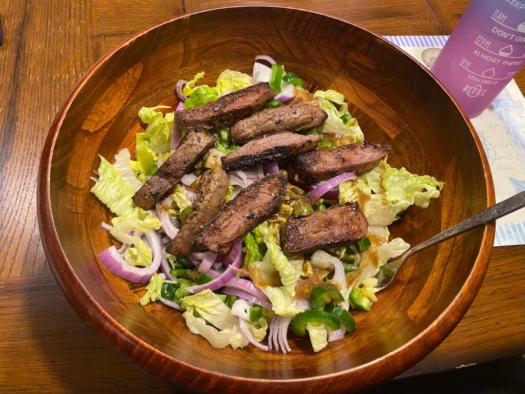 image shows finished healthy steak salad recipe in a bowl, ready to eat