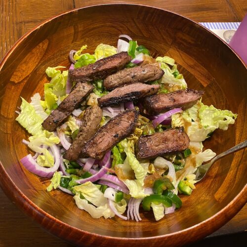image shows finished healthy steak salad recipe in a bowl, ready to eat