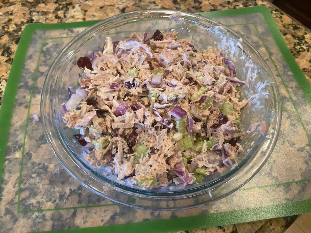 image shows bowl of cranberry tuna salad on kitchen island