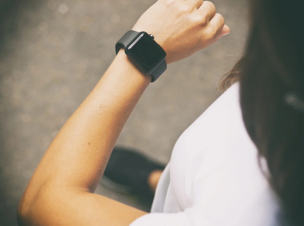 busy mom checking fitness tracker wondering are fitness trackers worth it
