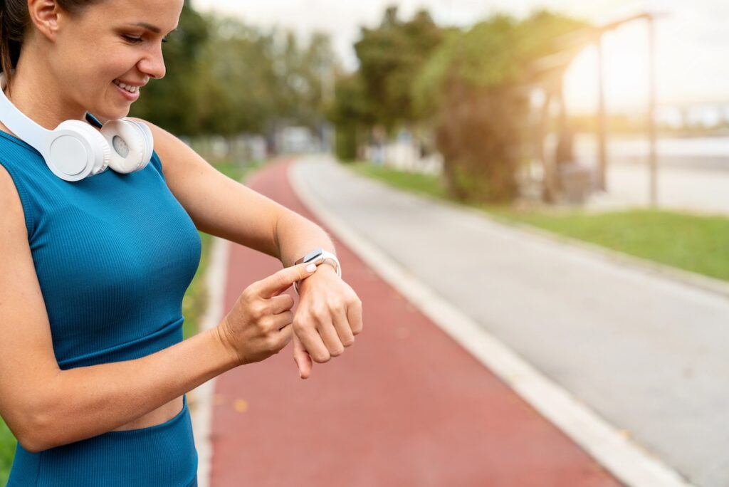 woman checking fitness tracker feeling motivated after workout