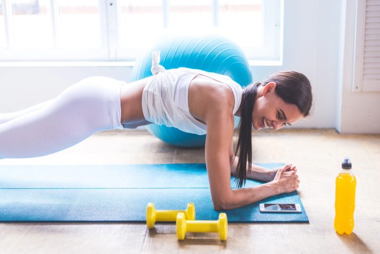 woman doing functional fitness workouts at home with dumbbells
