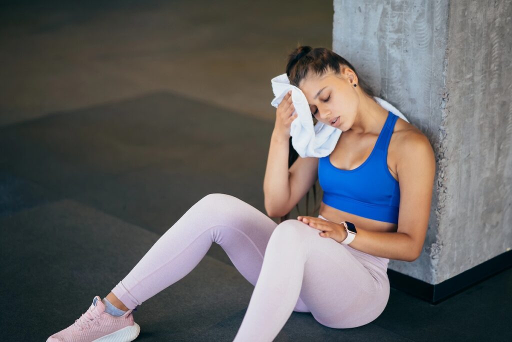 woman experiencing fatigue and burnout from too much cardio