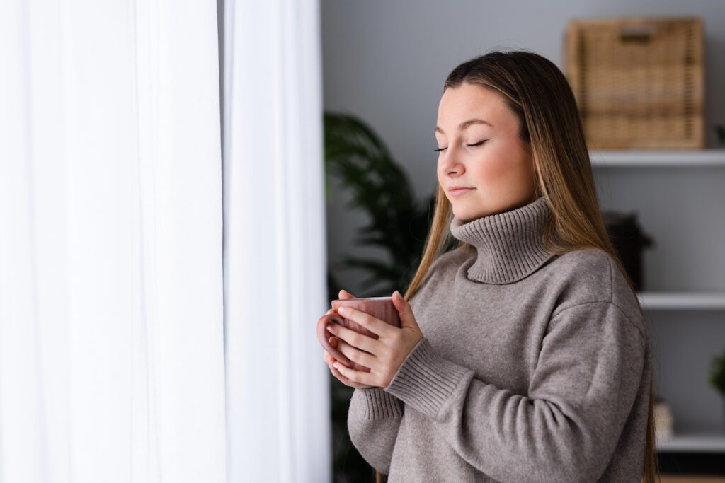 Woman taking a deep breath to calm her nervous system