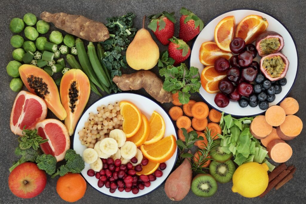 Fiber-rich carbs including berries, an apple, beans and a sweet potato